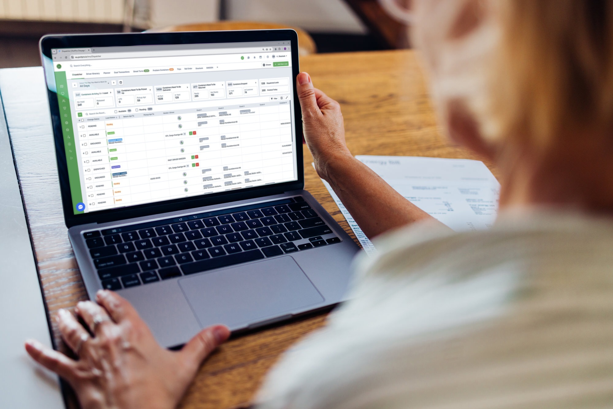 Person Analyzing Data Reports On Laptop Screen at Desk